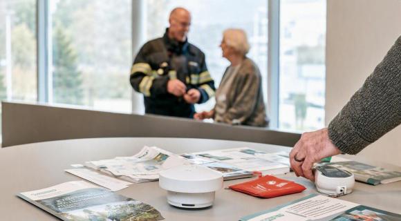 Informatiemarkt met de brandweer die met een dame praat